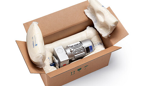 A cardboard box containing an engine component and foam packaging