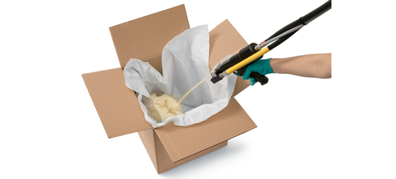 A foam gun being used to fill a cardboard box with adaptable foam packaging